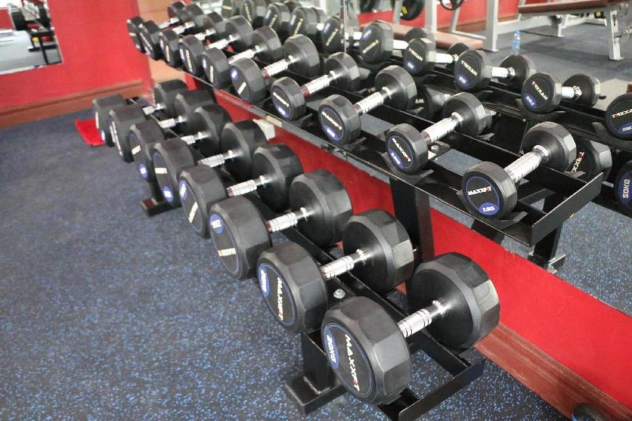 Fully equipped fitness room with free weights