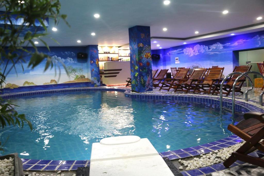 Indoor saltwater swimming pool with lounge chairs